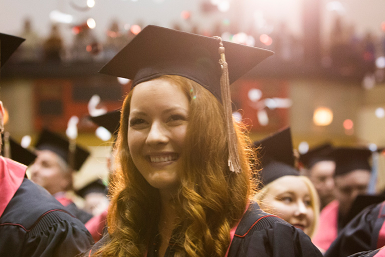 A joyful graduate at Commencement